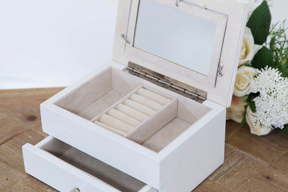 A wooden jewellery box with photo frame lid.